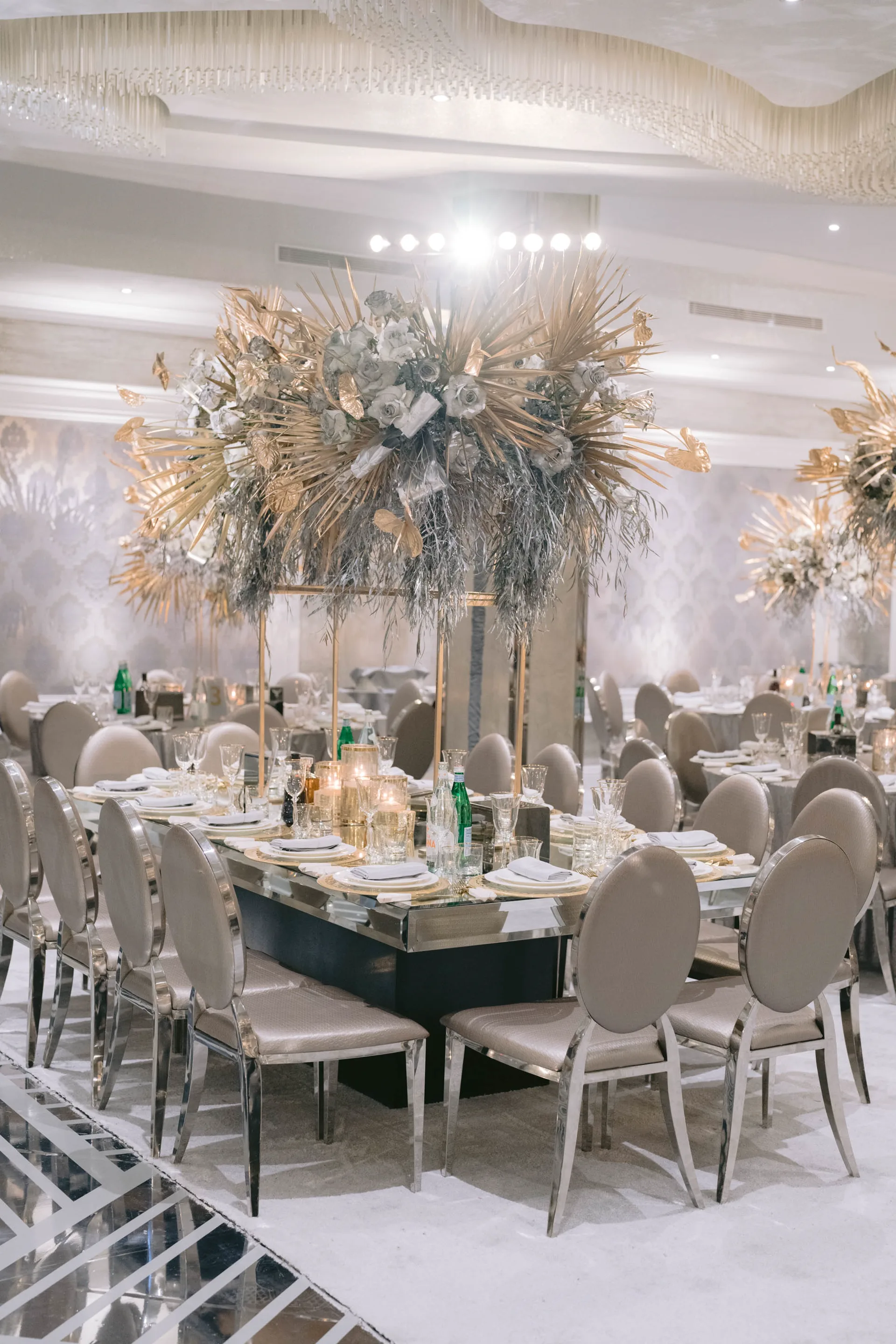 Crystal Ballroom — elegant wedding reception with gold palm leaf centerpieces